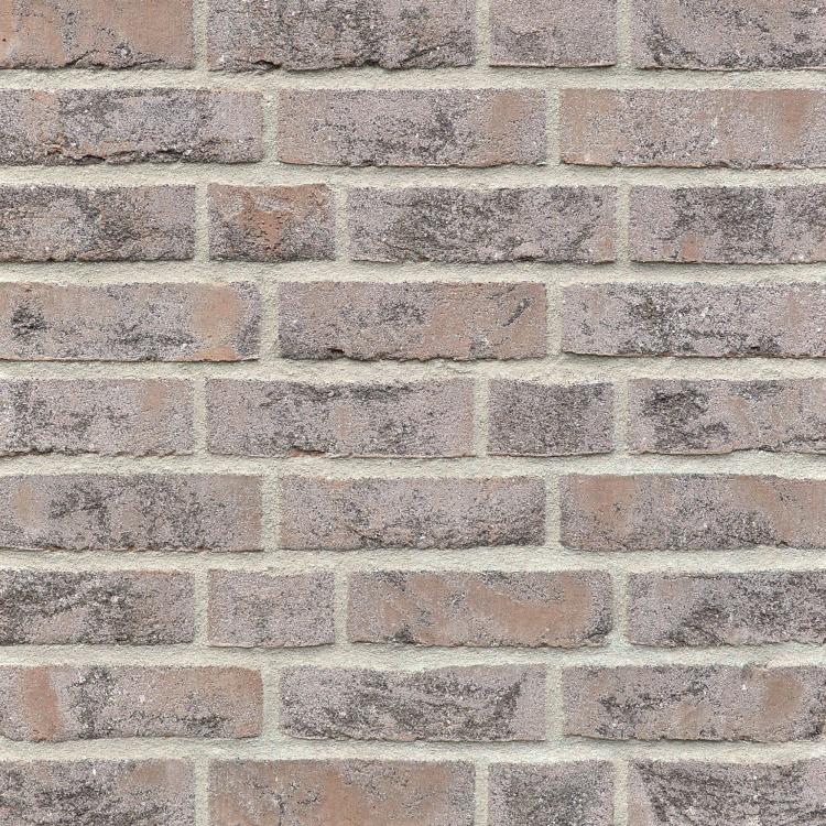 Ziegelwand aus roten und grauen Ziegeln.