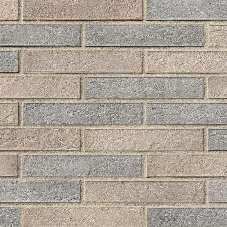 Ziegelmauer mit abwechselnd beigen und grauen Steinen.