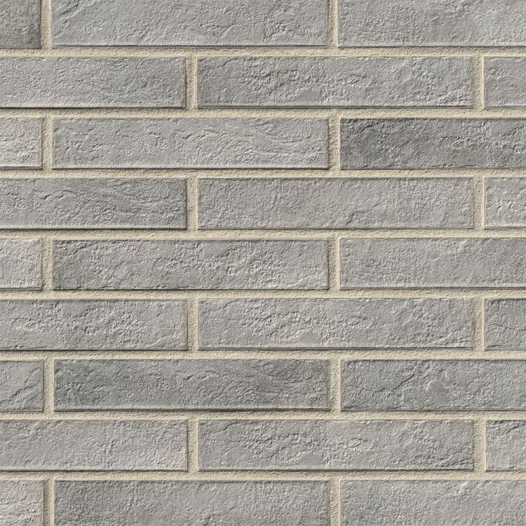 Graue Ziegelsteinmauer, strukturierte Oberfläche.