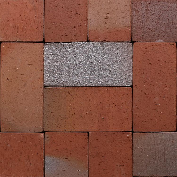 Rote und graue Ziegelsteine in einem Schachbrettmuster angeordnet.