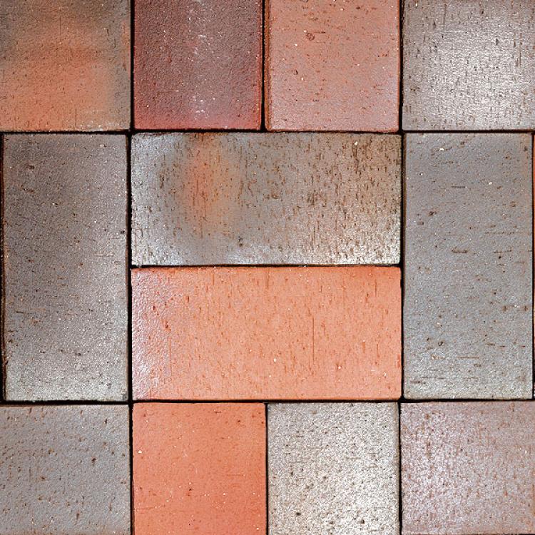 Rote und graue Ziegelsteine in symmetrischem Muster.