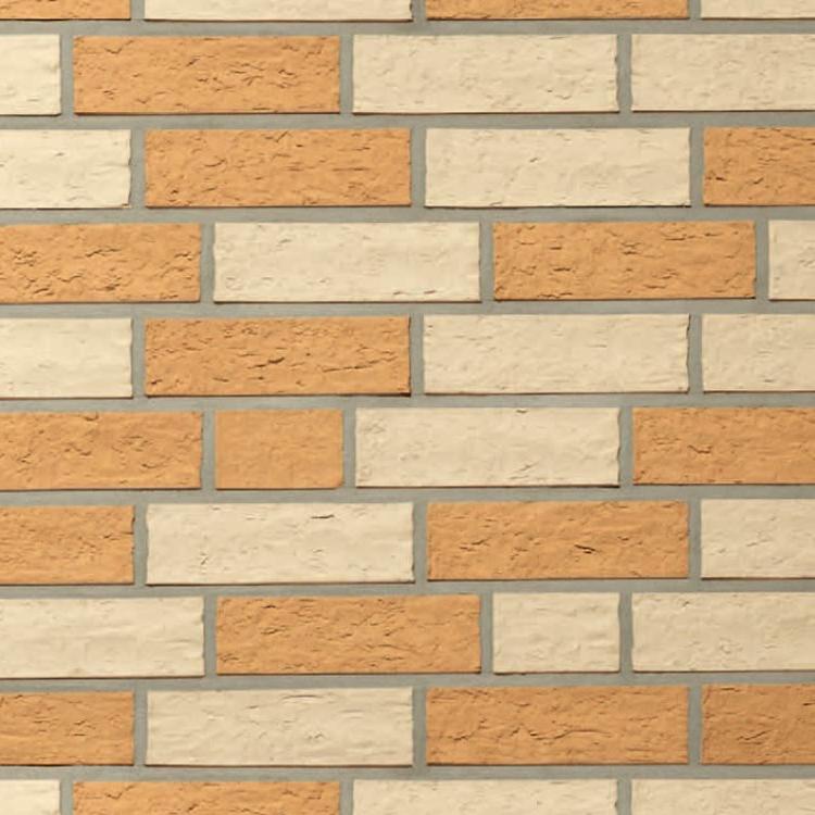 Klinkerwand mit orange und weißen Ziegeln in regelmäßigem Muster.