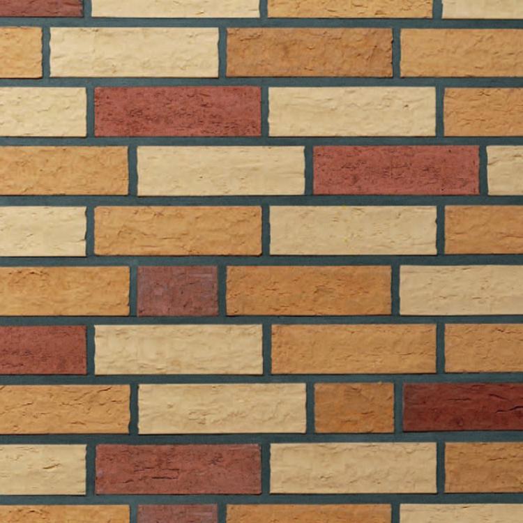 Wand aus gelben und roten Backsteinen in einem regelmäßigen Muster.